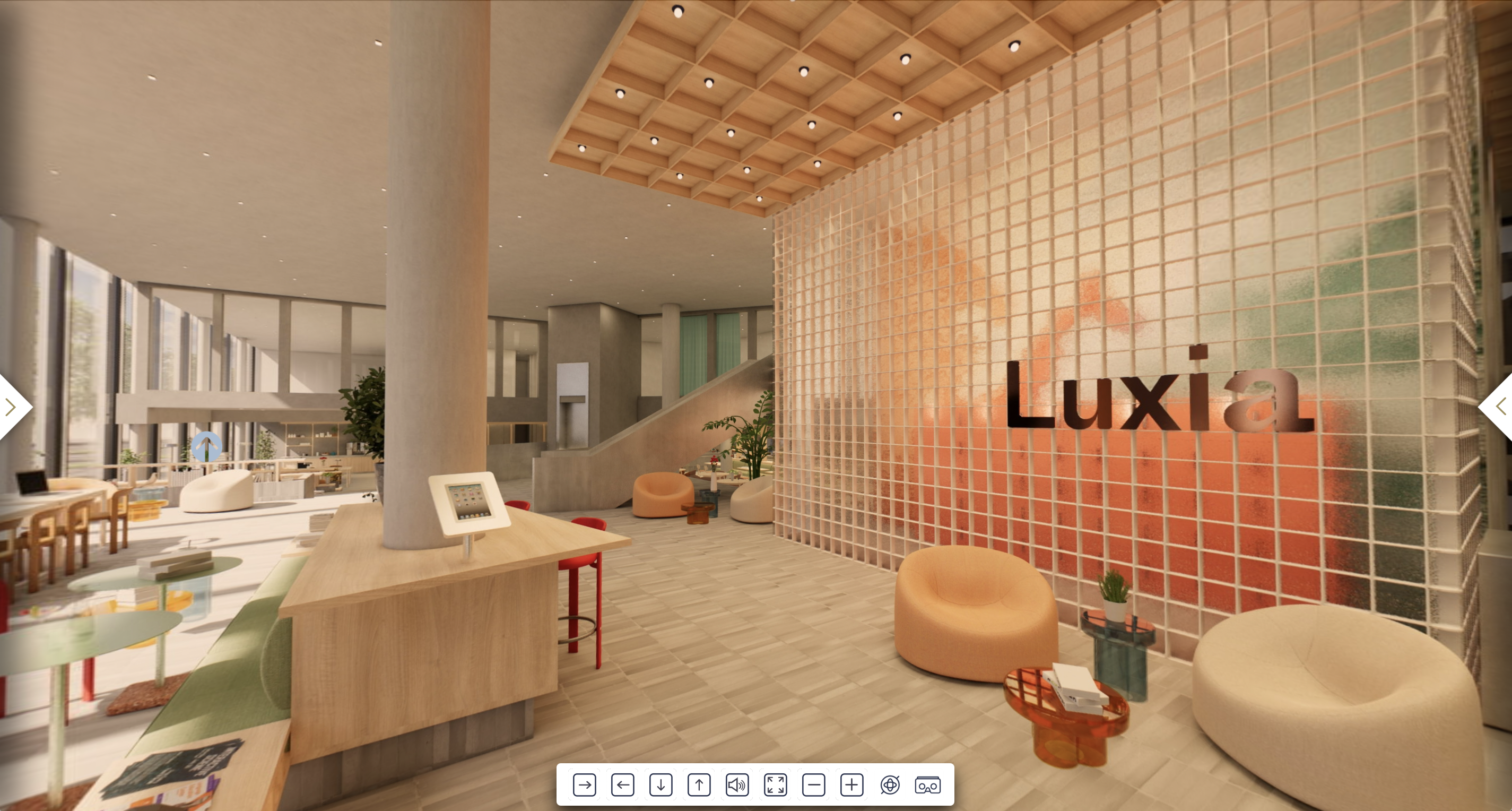 Lobby view of Luxia with custom furniture, natural light, and a prominent wall featuring the brand name in warm tones.