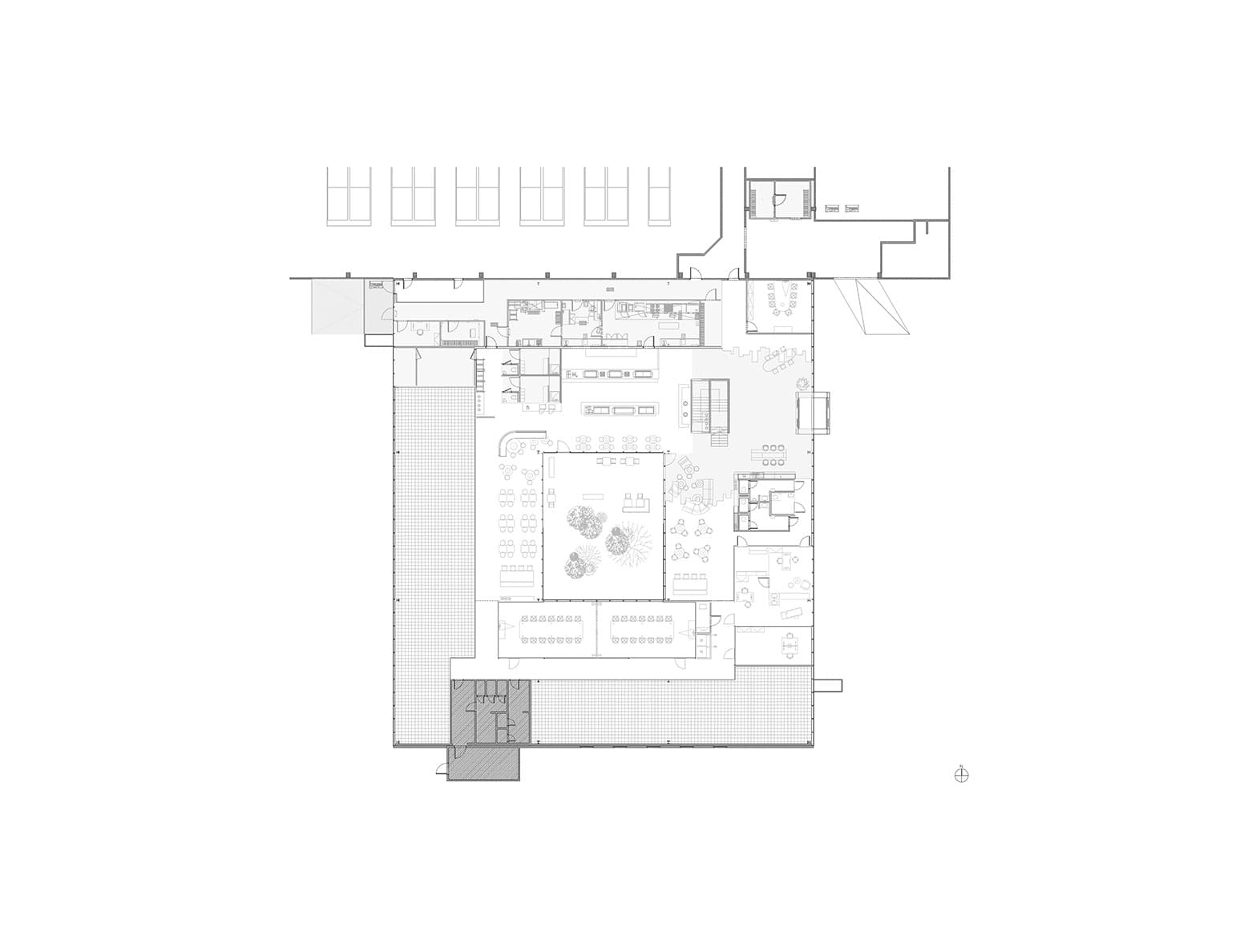 Detailed architectural floor plan in black and white showing the layout of workspaces, meeting rooms, and a central garden courtyard