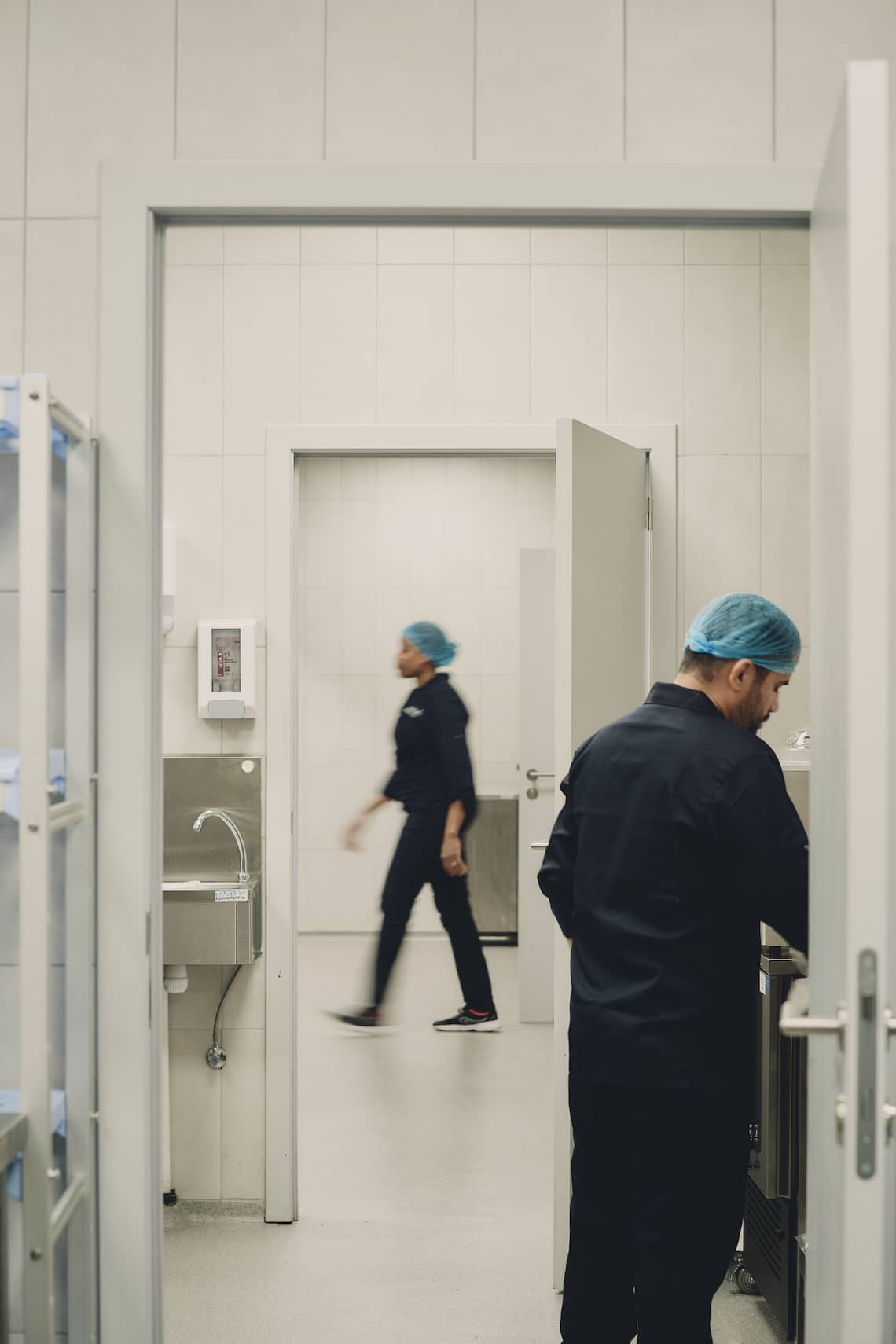Chef working with utensils in an organized and modern industrial kitchen space