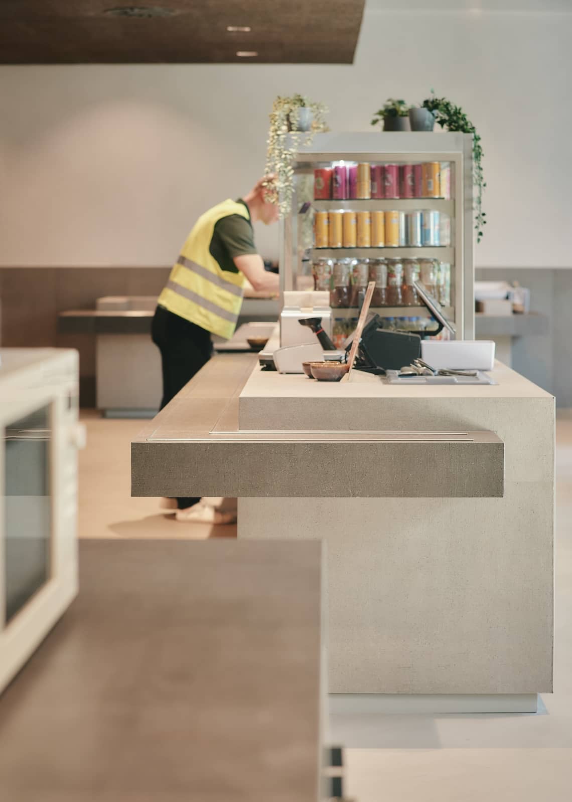 Group of people eating together in a cafeteria designed with sustainability principles