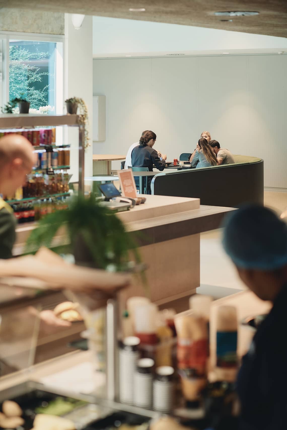 Close-up of food service with people in the background enjoying a sustainable dining space